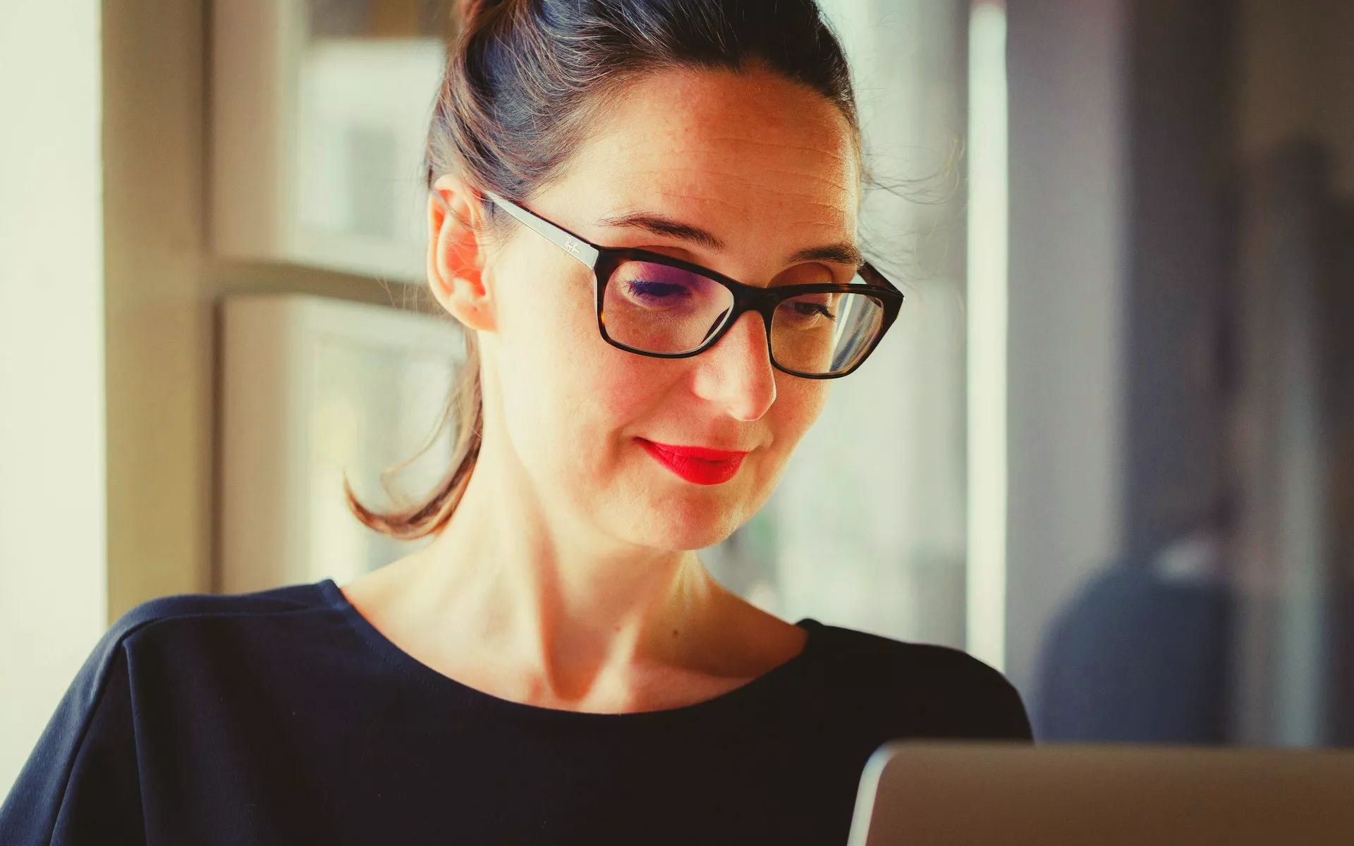 Woman behind MacBook